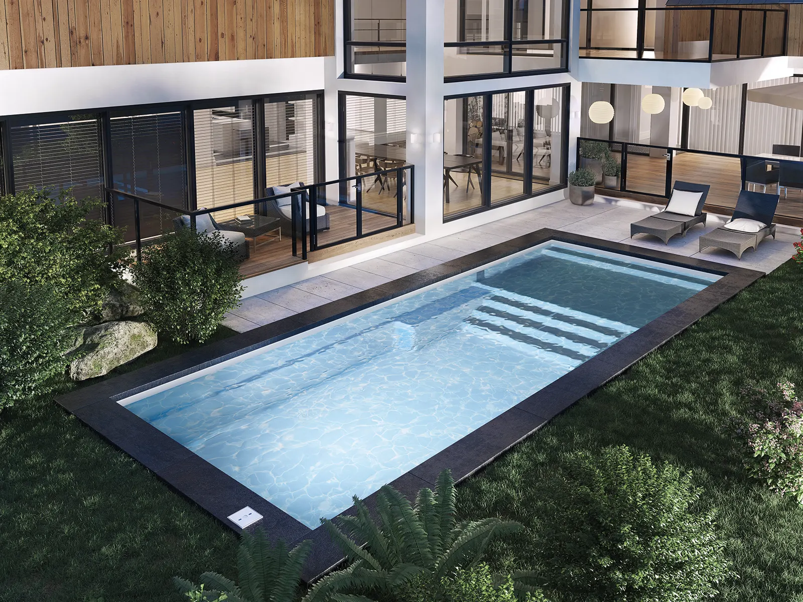 Piscine creusée en fibre de verre Mova, modèle 12x30 - Avec terrasse, finition Diamant couleur Mova, ambiance soirée éclairée