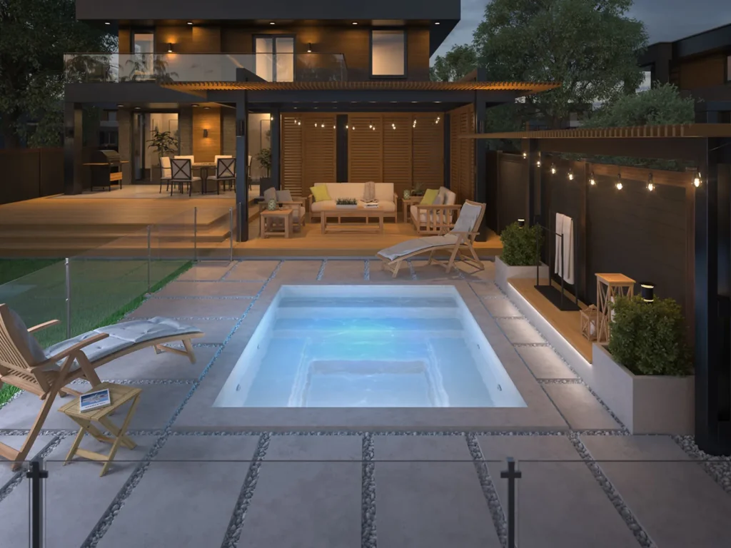 Piscine creusée en fibre de verre Mova, modèle 8x10, ambiance soirée éclairée