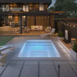 Piscine creusée en fibre de verre Mova, modèle 8x10, ambiance soirée éclairée